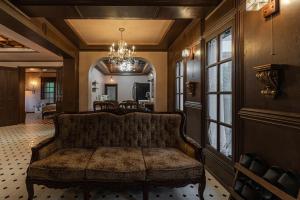 a living room with a couch and a dining room at Jeju Aewol Enoch Pool Villa in Jeju +51 photos