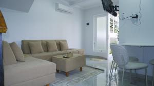 a living room with a couch and a table at Villa Dalia Puncak ACC9-18 in Cikujang