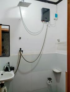 a bathroom with a shower with a tv on the wall at Zia Homestay in Burgos +62 photos