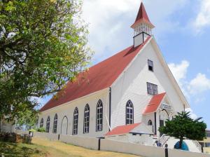 a large white church with a red roof at Honey Hill View in San Andrés
