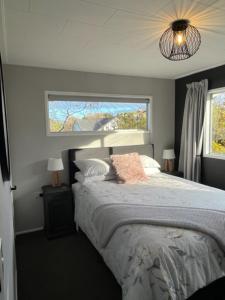 a bedroom with a bed and a window at Boutique on Russel in Invercargill
