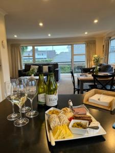 a table with two bottles of wine and wine glasses at Boutique on Russel in Invercargill
