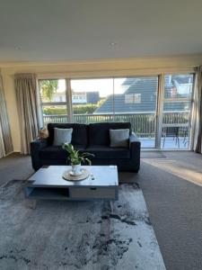 a living room with a couch and a coffee table at Boutique on Russel in Invercargill