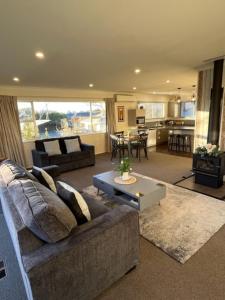 a large living room with a couch and a table at Boutique on Russel in Invercargill