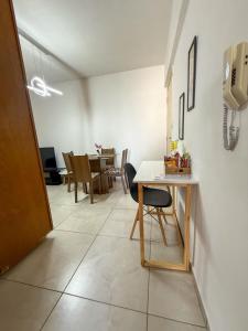 a living room with a table and a dining room at Apto Centro cambui em Campinas in Campinas +5 photos