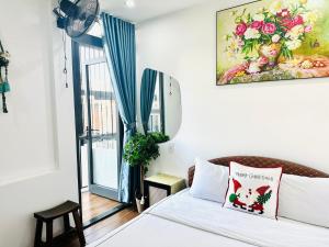 a bedroom with a bed and a window with a fan at New World Hotel in Hue
