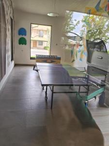 a room with a ping pong table in it at Hacienda Valbuena Antorcha area in León
