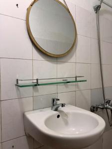 a bathroom with a sink and a mirror on the wall at Mộc Truly Huế - Homestay in Thôn Kim Long (1)