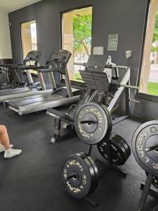 a gym with rows of treadmills and weights at Hacienda Valbuena Antorcha area in León