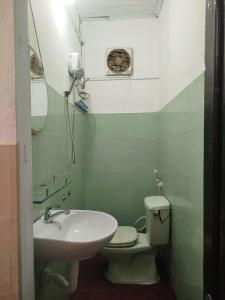 a bathroom with a toilet and a sink at Mộc Truly Huế - Homestay in Thôn Kim Long (1)