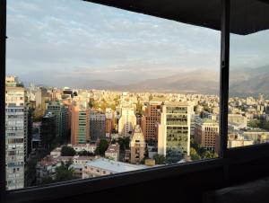 a view of a city from a window at Habitación privada con camarote en departamento compartido - Providencia in Santiago