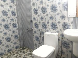 a bathroom with a toilet and a sink at Amber Residency in Ernakulam +19 photos