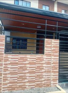 a building with wooden panels on the side of it at elisatransienthouse in Labac