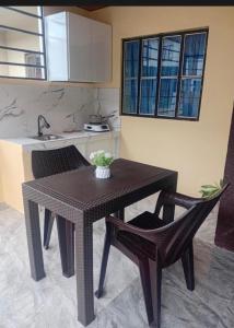 a kitchen with a table and two chairs and a sink at elisatransienthouse in Labac