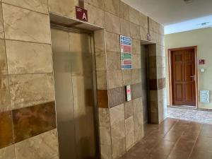an elevator in a building with a sign on the wall at Furnished Studio Apartment in Nairobi West in Nairobi +31 photos
