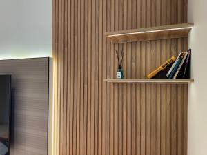 a wooden wall with a book shelf with books at Golden House Oz'Makon in Tashkent