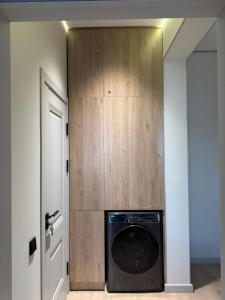 a washer and dryer in a room with a wooden closet at Golden House Oz'Makon in Tashkent