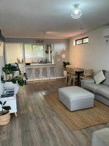 a living room with a couch and a table at Salty Soul Bungalow - Sauna! in Bicheno