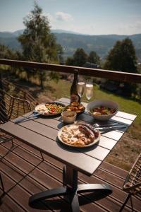 een tafel met drie borden eten en glazen wijn bij Shepit space in Slavske