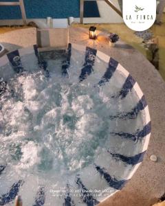 a bath tub filled with water in a room at La Finca - Eco Hotel in Cali