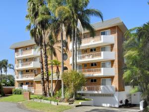 un immeuble avec des palmiers en face de celui-ci dans l'établissement Albacore 5, à Nelson Bay