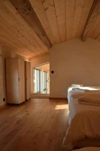 a room with two beds and a large window at Restored Farm Estate Near Atlantic Coast France in La-Gripperie-Saint-Symphorien