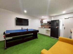 a room with a ping pong table in a kitchen at Banana Bunkhouse Hostel in Rawai Beach