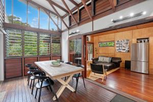a kitchen and living room with a table and chairs at Pandanus Retreat in Point Lookout