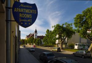 a sign for a restaurant on the side of a building at Villa Martini - apartments & rooms in Vukovar