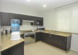 a kitchen with a blender on a counter at Phenomenal Location Near Beach & 5th with Stunning Roof Pool in Playa del Carmen