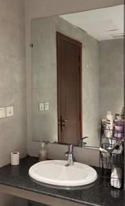 a bathroom with a sink and a large mirror at Indigo Luxury Premium Serviced Apartments Gulberg 3 - LMY Lahore in Lahore
