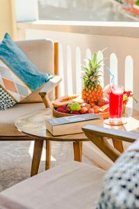 a table with a plate of fruit and a drink on it at Én Retreat Hoi An in Hoi An +67 photos
