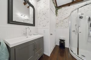a bathroom with a sink and a shower at Fishermans Cottage - Waikanae Beach in Waikanae +21 photos