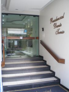 a lobby with a staircase in front of a store at Apartamento Dante Tomio in Balneário Camboriú