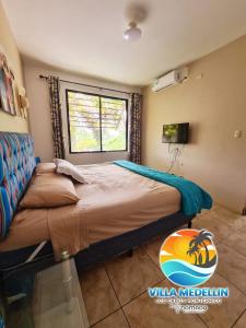 a bedroom with a large bed with a window at Villa Medellin Monterrico in Taxisco