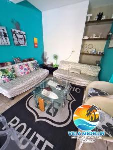 a living room with two couches and a table at Villa Medellin Monterrico in Taxisco