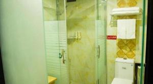 a bathroom with a glass shower and a toilet at GreenTree Alliance Ningbo Cixi Guanghaiwei Industrial Park East Area Hotel in Ningbo +150 photos