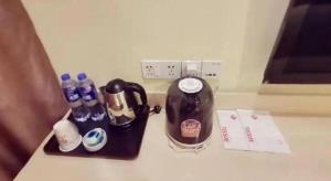 a counter top with a coffee maker and drinks on it at Pai Hotel Tianjin Binguan Metro Station Municipal Government in Tianjin