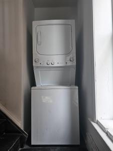 a microwave sitting on top of a refrigerator at Maple Manor Private in Saint Louis +4 photos