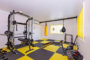 a fitness room with a gym with weights at Banana Bunkhouse Hostel in Rawai Beach