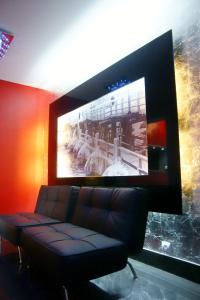 a living room with a couch and a flat screen tv at Villa Superiq Victus Sopot Walk to the Pier by Noclegi Renters in Sopot