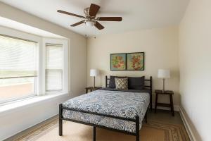 a bedroom with a bed and a ceiling fan at Comfortable 6BR Getaway • WiFi • AC • Pet-Friendly in Detroit