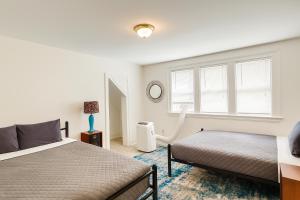 a bedroom with two beds and a window at Spacious 4BR Family Home in Detroit WiFi Parking in Detroit