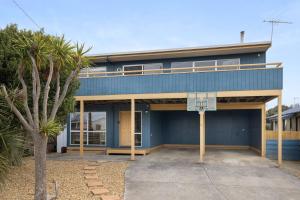 a blue building with a basketball hoop in front of it at Dragonfly Beach House in Sunderland Bay +7 photos