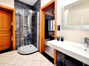 a bathroom with a sink and a shower at Countryside Escape for 9 in Honnay