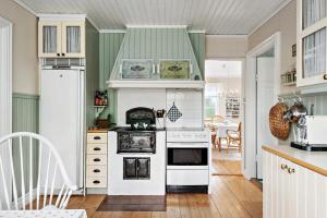 a kitchen with a stove and a white oven at Villa Berget in Fröseke