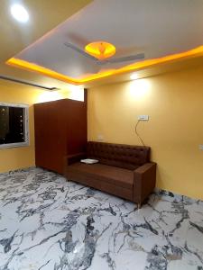 a room with a couch and a ceiling with a marble floor at Hotel Prince Bodh Gaya in Bodh Gaya
