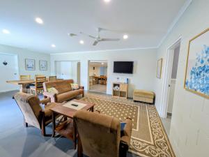 a living room with a couch and a table at Central Private Bedroom & Ensuite - City & Strand Beach Location in Townsville
