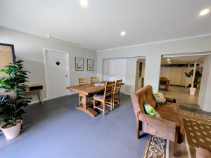 a living room with a wooden table and chairs at Central Private Bedroom & Ensuite - City & Strand Beach Location in Townsville