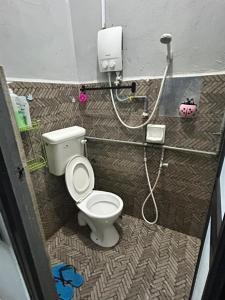 a small bathroom with a toilet and a shower at CILI PADI GUESTHOUSE in Kota Bharu +20 photos
